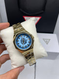 Guess gold-tone octagonal blue skeleton watch
